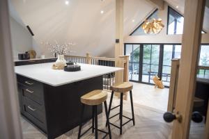 a kitchen with a counter and stools in a room at Highland House in Lochearnhead