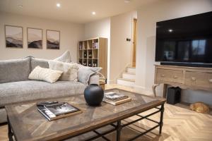a living room with a couch and a coffee table at Highland House in Lochearnhead
