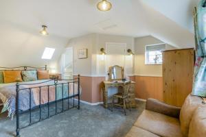a bedroom with a bed and a chair in a room at 2 Bed in Wickhampton oc-t34449 in Wickhampton