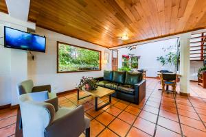 a living room with a couch and a tv at Mirando al Sur in San Carlos de Bariloche