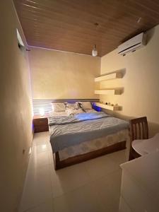 a bedroom with a bed in a room at Nara Cíntia in Luanda
