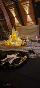 a table with a plate of food on a table at Cottage fairy in Dubrave Gornje