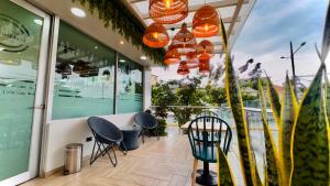 a restaurant with chairs and lights on a balcony at Hotel Puerto Pacifico Guayaquil Airport in Guayaquil