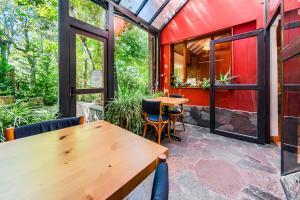 a patio with tables and chairs and a red building at Mirando al Sur in San Carlos de Bariloche