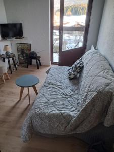 a bedroom with a bed with a dog sleeping on it at 265 rue du clos capperony in Les Rousses