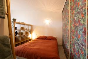 a bedroom with a bed in a room at La cabanne aux bambous in Villenave-dʼOrnon
