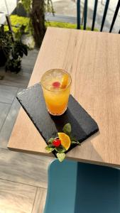 a glass of orange juice sitting on a table at Hotel Puerto Pacifico Guayaquil Airport in Guayaquil