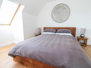 a bedroom with a large bed with a wooden headboard at Sealladh in Appin