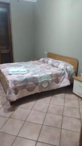 a bed in a bedroom with a tiled floor at Casa Castel San Giovanni in Castel San Giovanni