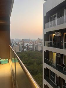 a balcony of a building with a view of a city at NEON - Nirvana Stays With PVT Balcony -1 Km from Airport in Pune