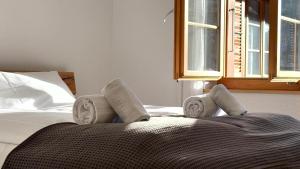 a bed with a pair of socks on top of it at Peacefull Mountains View in Kandersteg