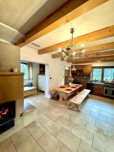 a large kitchen with a table and a fireplace at Chata Paradise in Smižany
