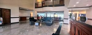 a lobby with couches and chairs in a building at Hotel Willowbrook in Houston