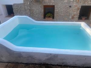 a pool with blue water in a house at Campus el abuelo in Denia