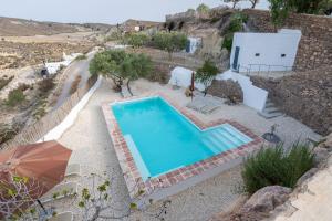 an overhead view of a swimming pool with an umbrella at Casa Ubedas in Almería