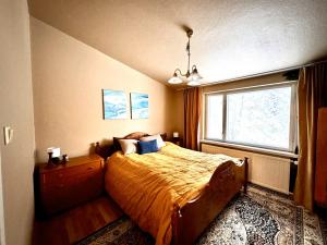 a bedroom with a bed with a large window at Guesthouse Sahanpera in Rovaniemi