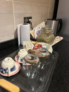 a tray with dishes and jars on top of a counter at Villa Paula in Ranchos +4 photos