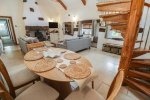 a table and chairs in a room with a living room at Riverside Barn in Truro
