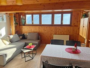 a living room with a couch and a table at Hotel Bellevue in Sierre