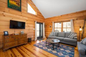 a living room with a couch and a tv at The Treehouse at the Rustic Retreat in Nashville