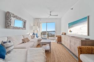 a living room with a couch and a table at Harbor Cove 404 in Orange Beach