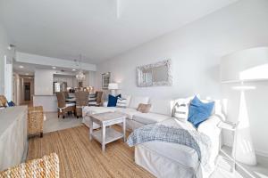 a living room with a white couch and a table at Harbor Cove 404 in Orange Beach