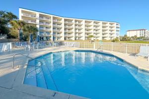 a swimming pool in front of a apartment building at Harbor Cove 404 in Orange Beach