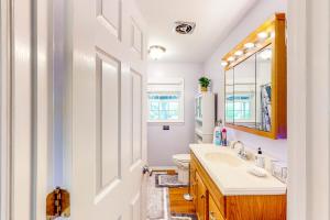 a bathroom with a sink and a toilet and a mirror at Danielsville Home on Sprawling Acreage w/ Views! in Commerce +19 photos