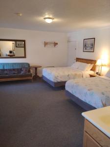a hotel room with two beds and a couch at acadia sunrise motel in Trenton