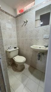 a bathroom with a toilet and a sink at Casa Turística Samanta in Buga