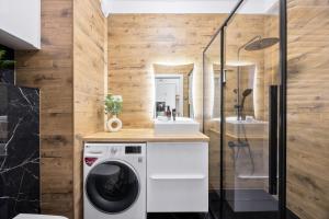 a laundry room with a washer and dryer at Hygge Amber Aparts - 9th floor in Gdańsk Letnica