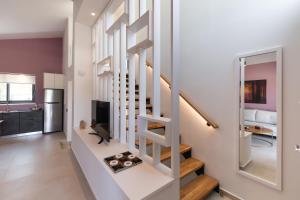 a spiral staircase in a living room with a kitchen at RIZOMATA LUXURY VILLAS in Lefkada