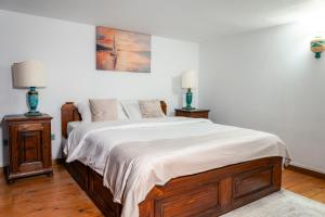 a bedroom with a large bed with two lamps at Baroque Residence in Timişoara