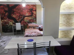 a table and chairs in a room with a painting on the wall at Bandirma Saglik Apart in Bandırma