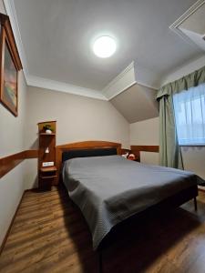 a bedroom with a large bed in a room at Keller Apartman in Cserszegtomaj