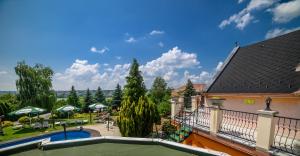 a view from the balcony of a house with a swimming pool at Keller Apartman in Cserszegtomaj