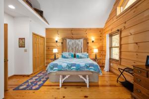 a bedroom with a bed and wooden walls at The Treehouse at the Rustic Retreat in Nashville
