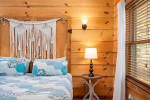 a bedroom with a bed and a lamp and wooden walls at The Treehouse at the Rustic Retreat in Nashville +11 photos