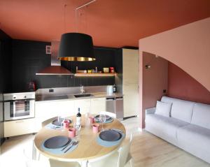 a kitchen and dining room with a table and a couch at Milk River - beach front, railway station, lake view in Varenna