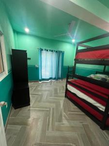 a bedroom with a bunk bed and a wooden floor at Exclusive paradise surrounded by nature in Alpuyeca
