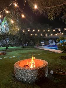 a fire pit in the middle of a yard at night at Exclusive paradise surrounded by nature in Alpuyeca +10 photos