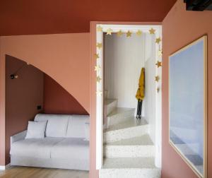 a bedroom with a stairway leading up to a bed at Milk River - beach front, railway station, lake view in Varenna +28 photos