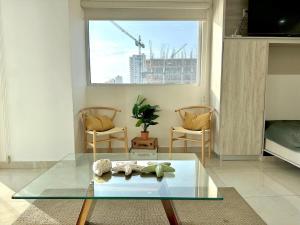 a living room with a glass table and two chairs at Sunset view luxury in Cedro