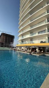 a swimming pool in front of a large building at Sunset view luxury in Cedro