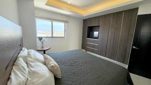 a bedroom with a bed and a tv and a window at Sunset view luxury in Cedro +29 photos