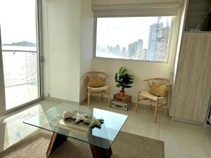 a living room with a glass table and chairs at Sunset view luxury in Cedro