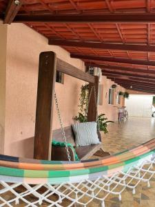 a porch with a hammock in a house at Raízes do Cerrado in Cavalcante