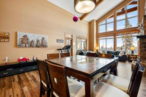 a dining room with a table and a couch at Blackrock 6 in Big White