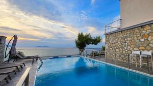 a swimming pool with a view of the ocean at Hill Suites in Vlorë