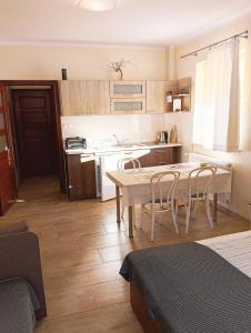 a kitchen with a table and chairs in a room at KAJA Zawoja in Zawoja